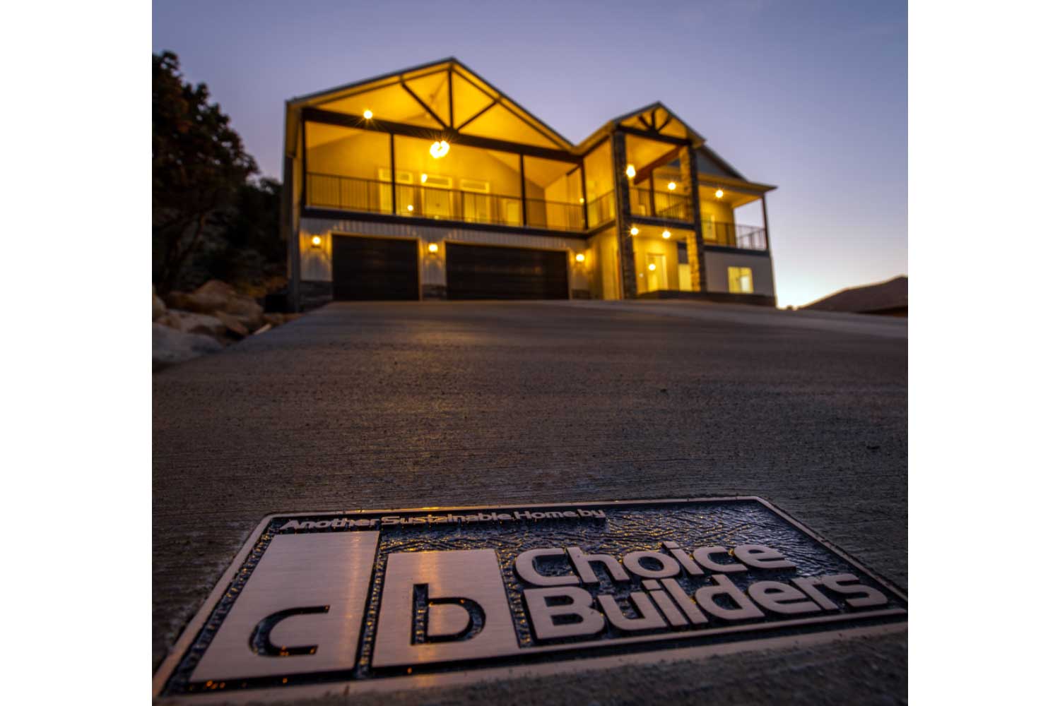 Metal stamped Choice Builders logo embedded in driveway