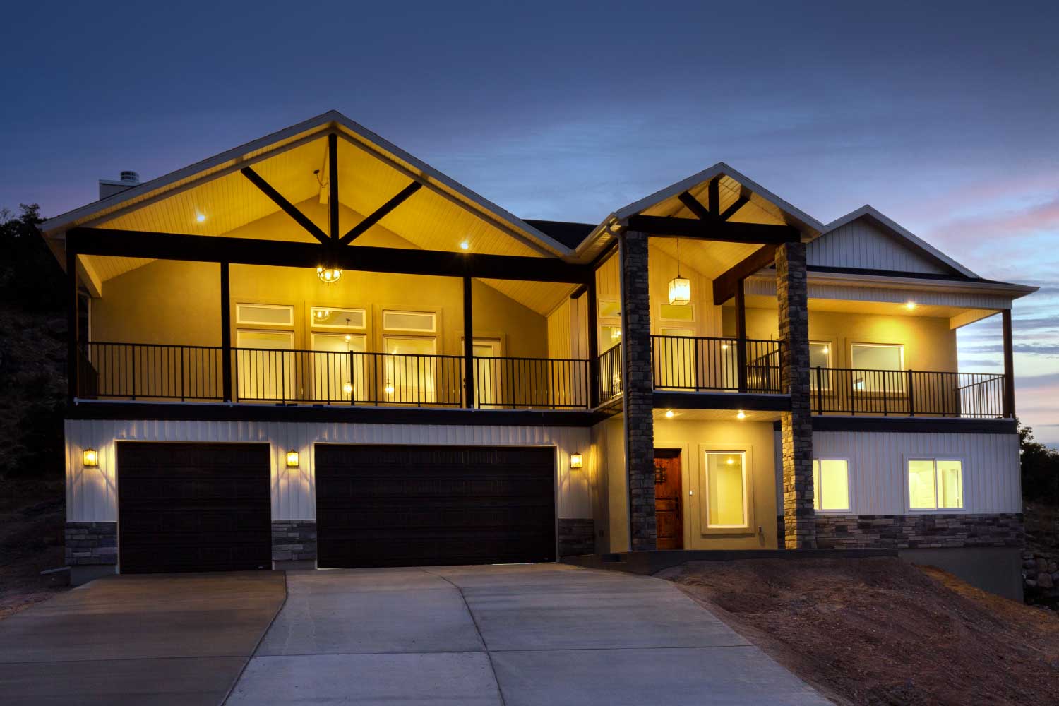 Front of two story house with three car garage at night