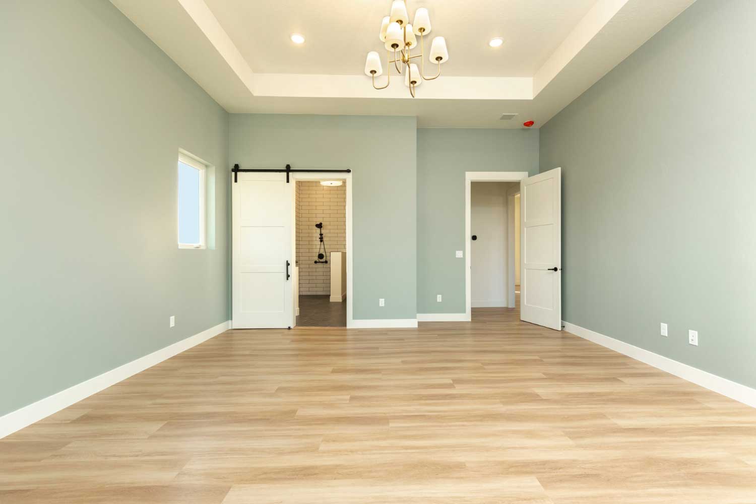 Soft sage colored walls in the primary bedroom
