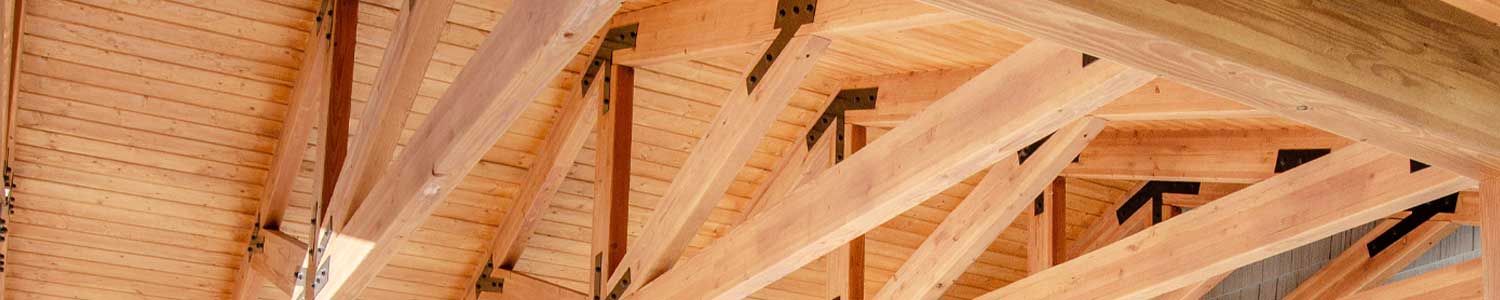 new construction using stained wood framing of outdoor pavilion showing joists 