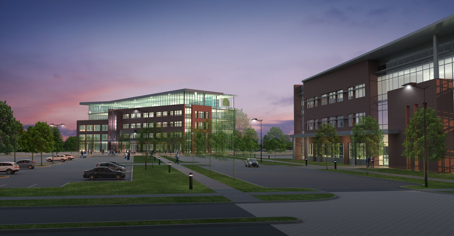 modern office buildings at dusk with illuminated windows and landscaped parking areas