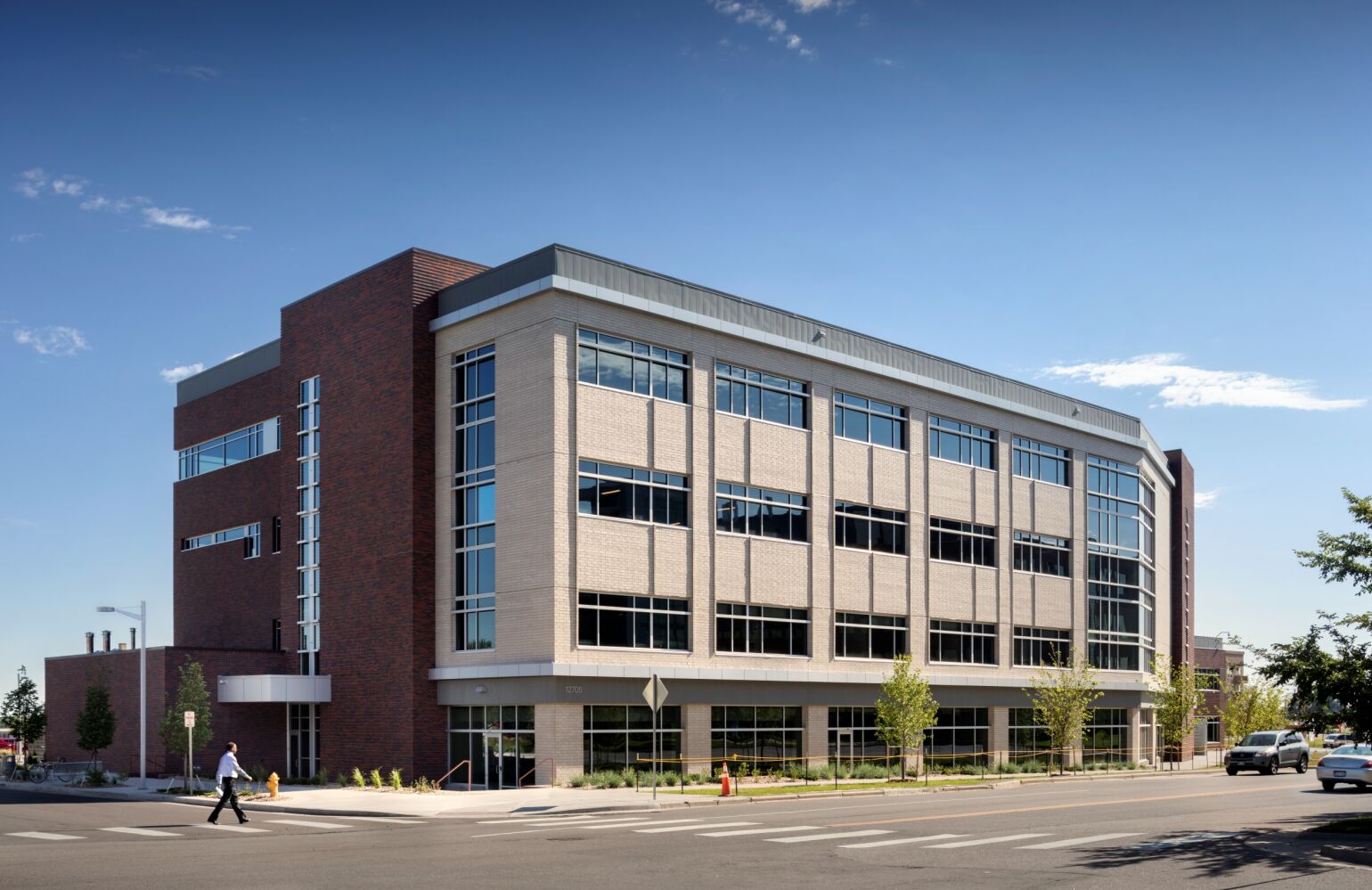 Exterior of the Bioscience 2 building with brick and light‑panel façades and large vertical windows.