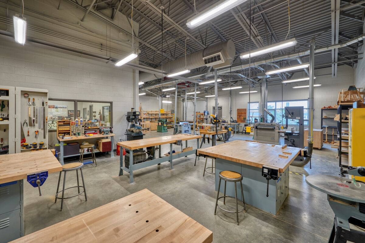 The Deer Trail PK–12 School CTE maker lab with workbenches, industrial equipment, storage shelves, and tools arranged throughout the open workspace.