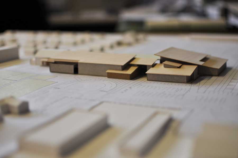 Cardboard building mock ups displayed on top of achematic drawing